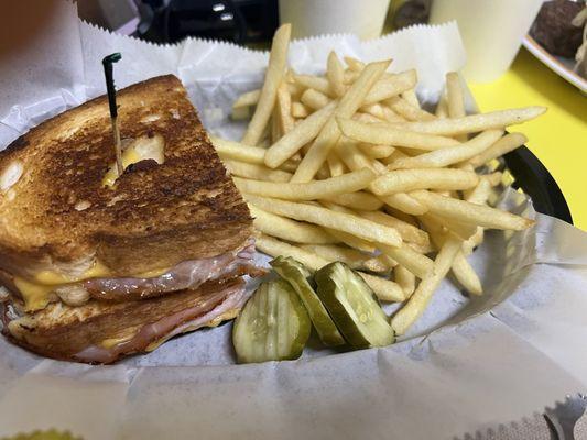 Ham and cheese sandwich served with fries