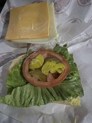 This looks like jail food. Only the American cheese was edible. The pickles and peppers were gooey and old and the bread was hard.