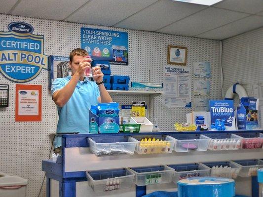 Brandon, one of our water chemistry specialists, assesses one of our customer's Pool Water for chemical balance.