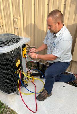 Ebens Air Conditioning Technician outside working on Condenser.