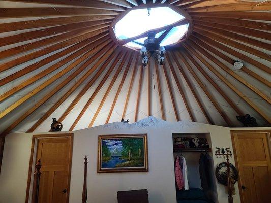 Interior of the Yogi Bear themed yurt. Note the painted snow capped peaks on the wall dividing bedroom from bathroom!