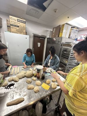 The group separating their dough and getting ready to braid their designs.