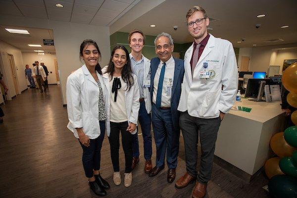 Our NEW Chairman, Ramesh Ayyala, MD, with several residents at the Grand Opening.