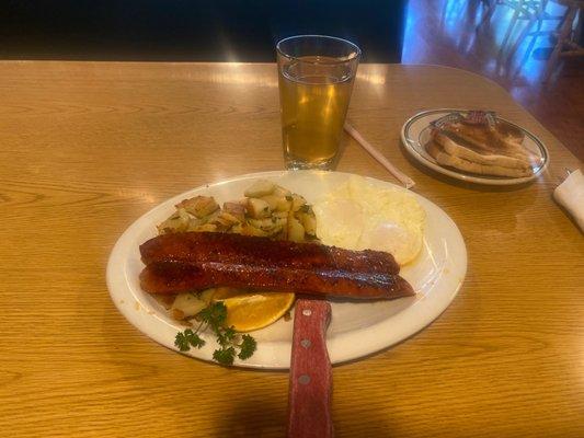 Linguica and eggs and sourdough bread and an apple juice.