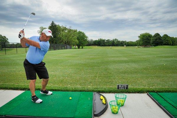 Full-service practice facility with grass tee and mats.