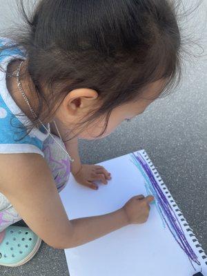 A preschooler making art at Cultivate