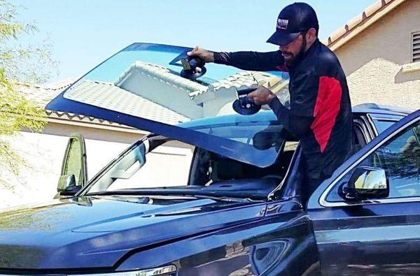 Derric setting a Windshield on a 2017 Lifted Chevy Tahoe