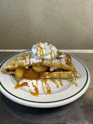 stuffed waffle with apple & cream cheese topped with whipped cream & caramel drizzle