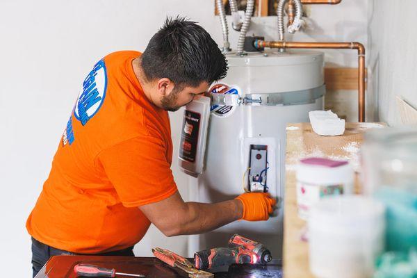 Antonio, repairing an electric water heater, ensuring the customers hot water needs are promptly restored.