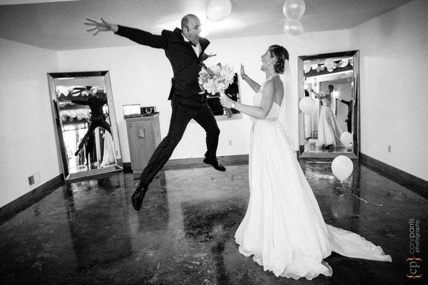 Groom jumping for joy after his wedding ceremony at Dragonfly Retreat in Bothell.