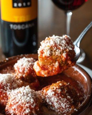 House Meatballs baked in tomato sauce and topped with freshly grated parmesan