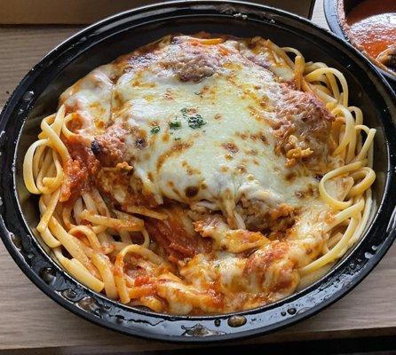 Veal parmigiana over spaghetti for take-out. Delicious and came piping hot!