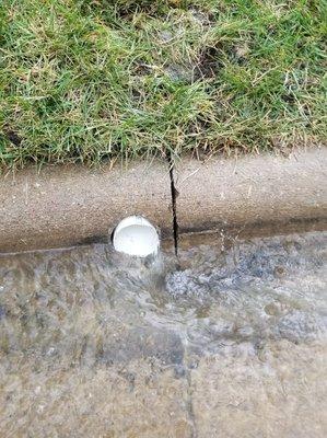 This is one of the downspout drains that we repaired. The drain water was pushing the street water away.