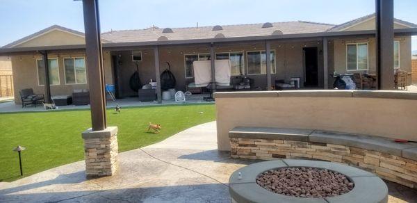 Background:1500 sq ft covered patio. Foreground: Gas fire pit.