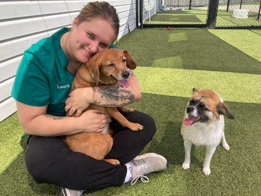 Laura - one of our kennel and front desk team members loving on boarding pups