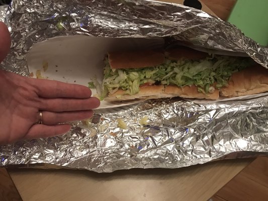 HUGE Lg sized-it's like a foot and a half! (See my hand for perspective) Cheeseburger grinder with mushroom onion and peppers.