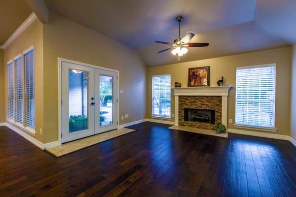 New wood floors replaced old stained carpet.  New fireplace brick replaced old dated tile.