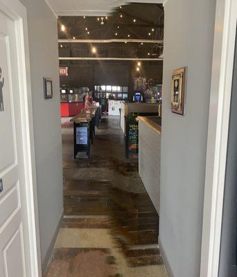 Entry hallway with restrooms surrounded with historical site pics on the wall