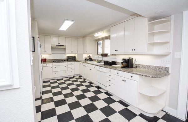 Large kitchen with oodles of cabinet space and three refrigerators for our residents.