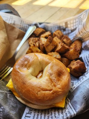 Egg and cheese bagel with side of home fries