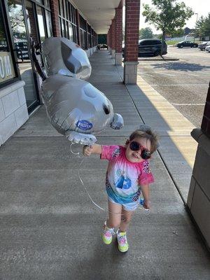 My daughter (Hazel) with the Olaf balloon we just bought.