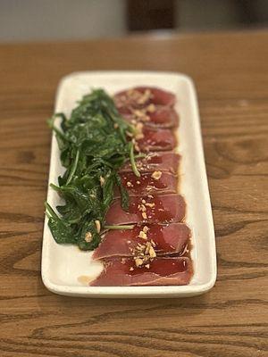 Tuna Tataki: Slices of seared Cajun tuna served with sauteed spinach with roasted garlic & sweet-ponzu dressing | $17.95