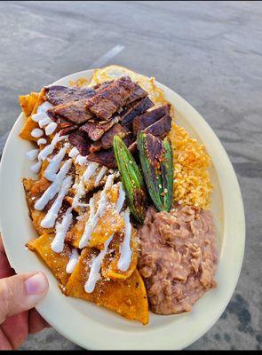 Chulaquiles! With some Carne Asada  followed by rice & beans.