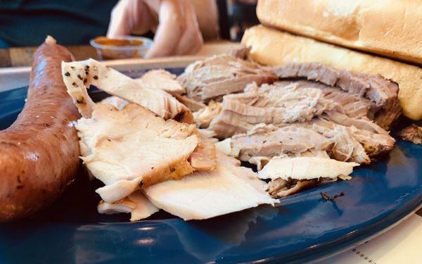 Sampler platter with turkey, brisket, and pork barbecue