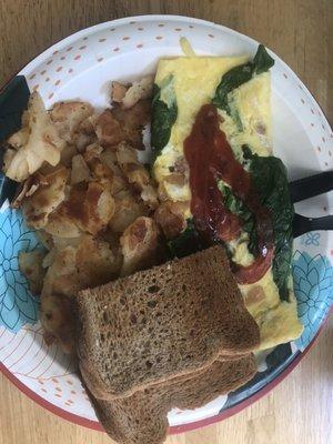 Bacon and spinach omelette with home fries