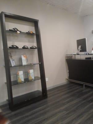 Shelf of flip flop display. Love his flooring, lol.