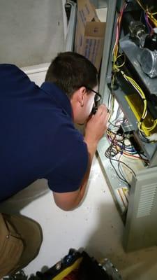 Inspecting the furnace.