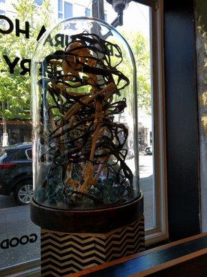 Bell jar sculpture in the window.