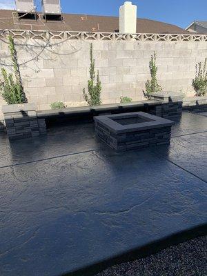 Fire pit on stamped concrete with sitting bench