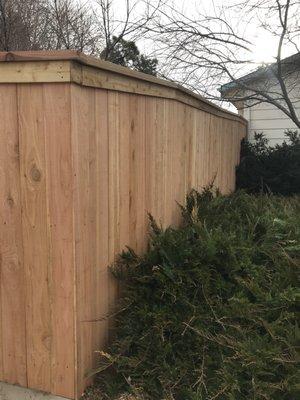 Fence as it runs up incline, with added top cap.