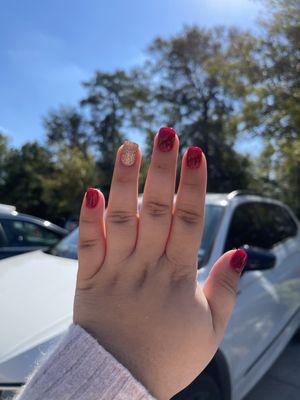 Burgundy and gold glitter dipped nails.