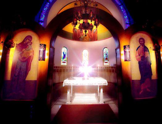 Illuminated cross on the altar table. I took this photo with my Google Pixel 4a 5g.