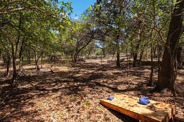 Cornhole and Star gazing slab near the zip line and axe throwing wall