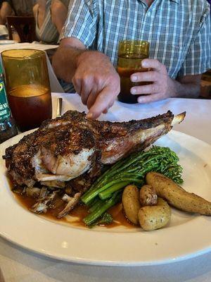 Touching the grilled crust on this thick chop.