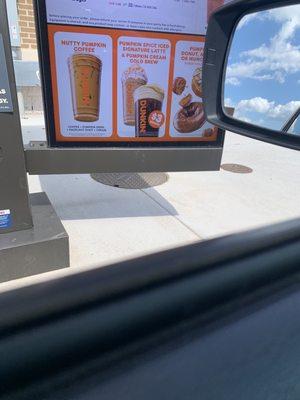 Sign in drive through indicating $3 for a medium iced pumpkin latte that I was charged $4.89