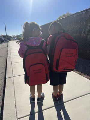 Ready for school with their backpacks