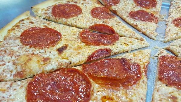 Thin crust pepperoni pizza pie by Casero's