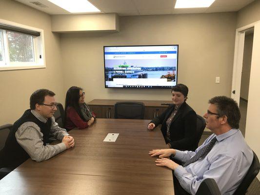 Conference room w/ 4K display & Polycom conference phone.