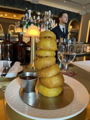 Light tempura style onion rings, very thick. No sliding out the batter.