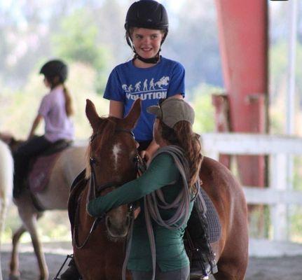 STRIDES owner Maggie giving a student a pep talk before working on cantering. The pony featured in this picture is the famous Clover :)