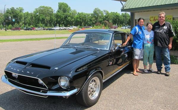 Helen posing with son, Kevin and Dan Matila with the GT500