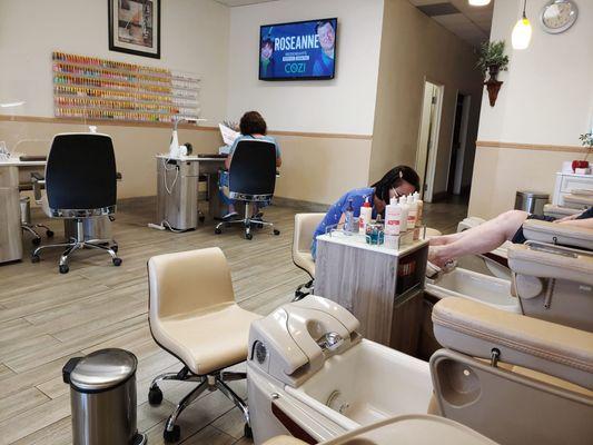 Back of salon, showing mani and pedi stations, and doorway to wax room