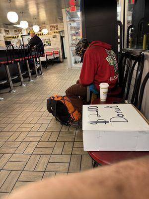 Homeless man selling donuts inside the Waffle House on Parvin  road