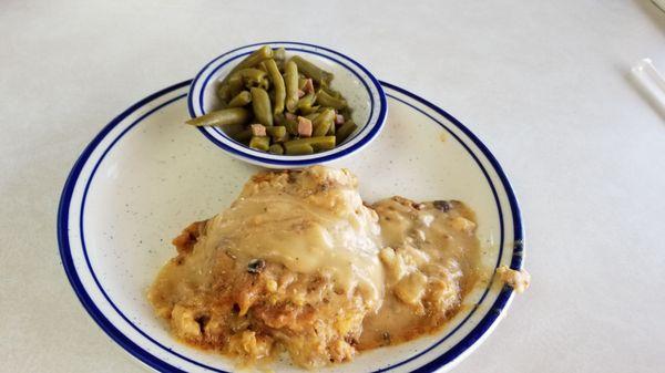 Smothered pork chop that was bland and overcooked.