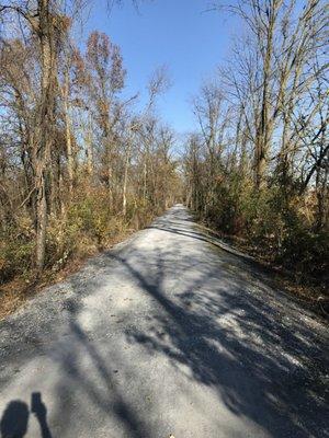 Trail is relatively narrow, rounded, with ditches on both sides. Exposed gravels in many areas make rough rides.