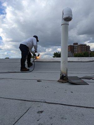 DURING: Team hear at work laying down the roof. Blowtorches are cool :)